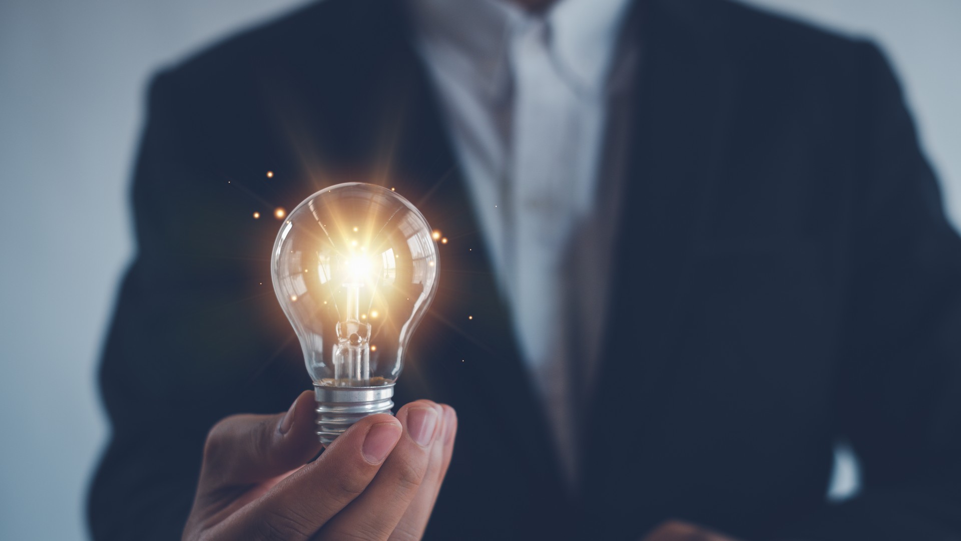 Idea innovation and inspiration concept.Hand of man holding illuminated light bulb, Idea innovation and inspiration concept.  creativity with bulbs that shine glitter, Concept for success.